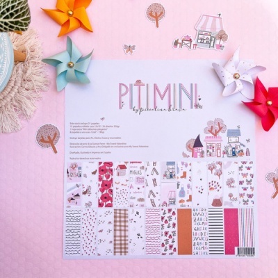 Folha de papel scrapbooking rosa com padrões infantis e cataventos coloridos