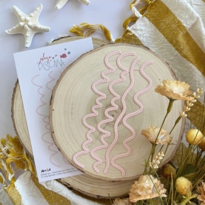 Fitas decorativas cor-de-rosa em base de madeira com cartão e flores secas ao redor