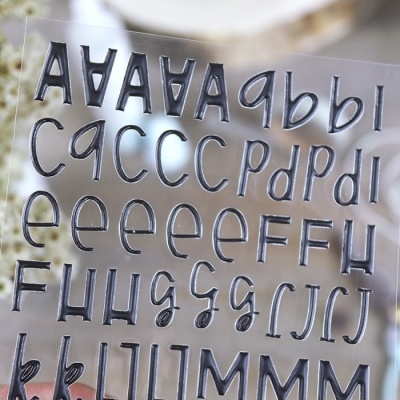 Folha transparente com letras autocolantes pretas em relevo