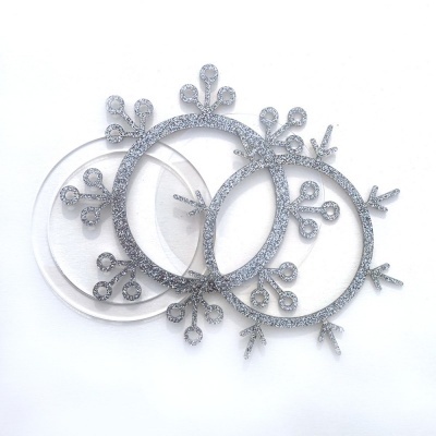 Três moldes redondos para artesanato em forma de flocos de neve com glitter prateado e transparente