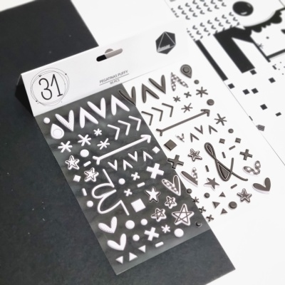 Folhas de autocolantes transparentes com padrões em preto e branco numa mesa, embaladas com etiqueta branca onde lê-se PEGATINAS PARTY e número 31.
