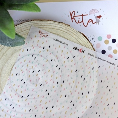 Folhas de papel decorativo com padrões coloridos e marca Kita para scrapbooking