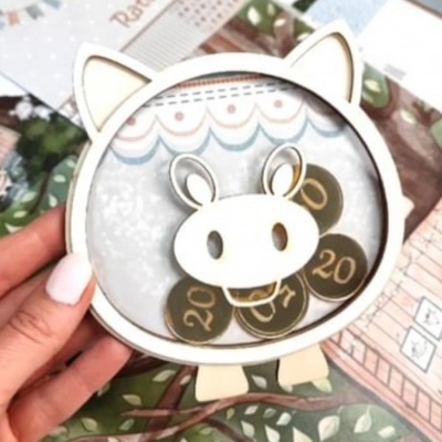 Suporte em forma de vaca com moedas numeradas 20 e 27