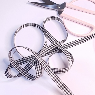 Fita xadrez preto e branco com tesoura rosa claro