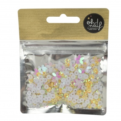 Pacote transparente com lantejoulas coloridas e etiqueta preta oh naif