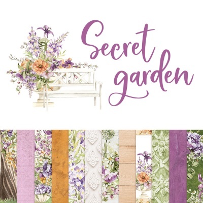 Papel decorativo floral e texto Secret garden ao lado de banco branco com flores.