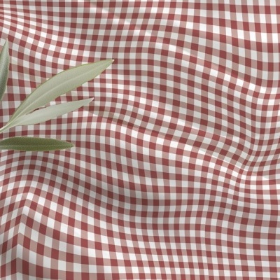 tecido xadrez vermelho e branco com ramo de folhas verdes