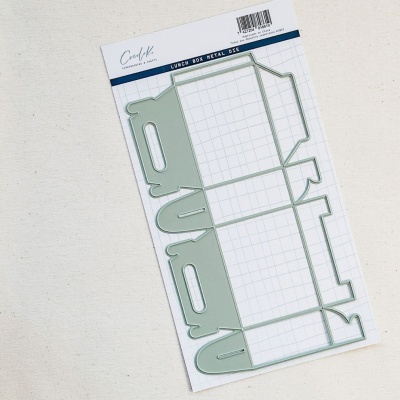 Placa metálica para corte de papel para caixa lunch box em fundo branco com quadrícula