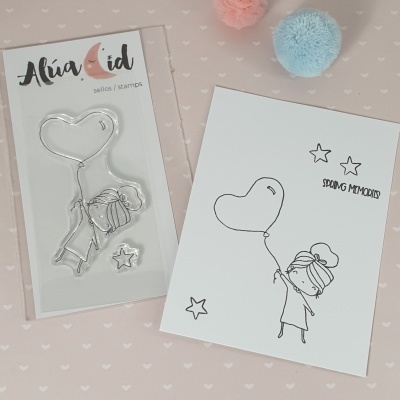 Selo de silicone com desenho de menina e balão em forma de coração em embalagem ao lado de papel com carimbo usado e texto SPRING MEMORIES