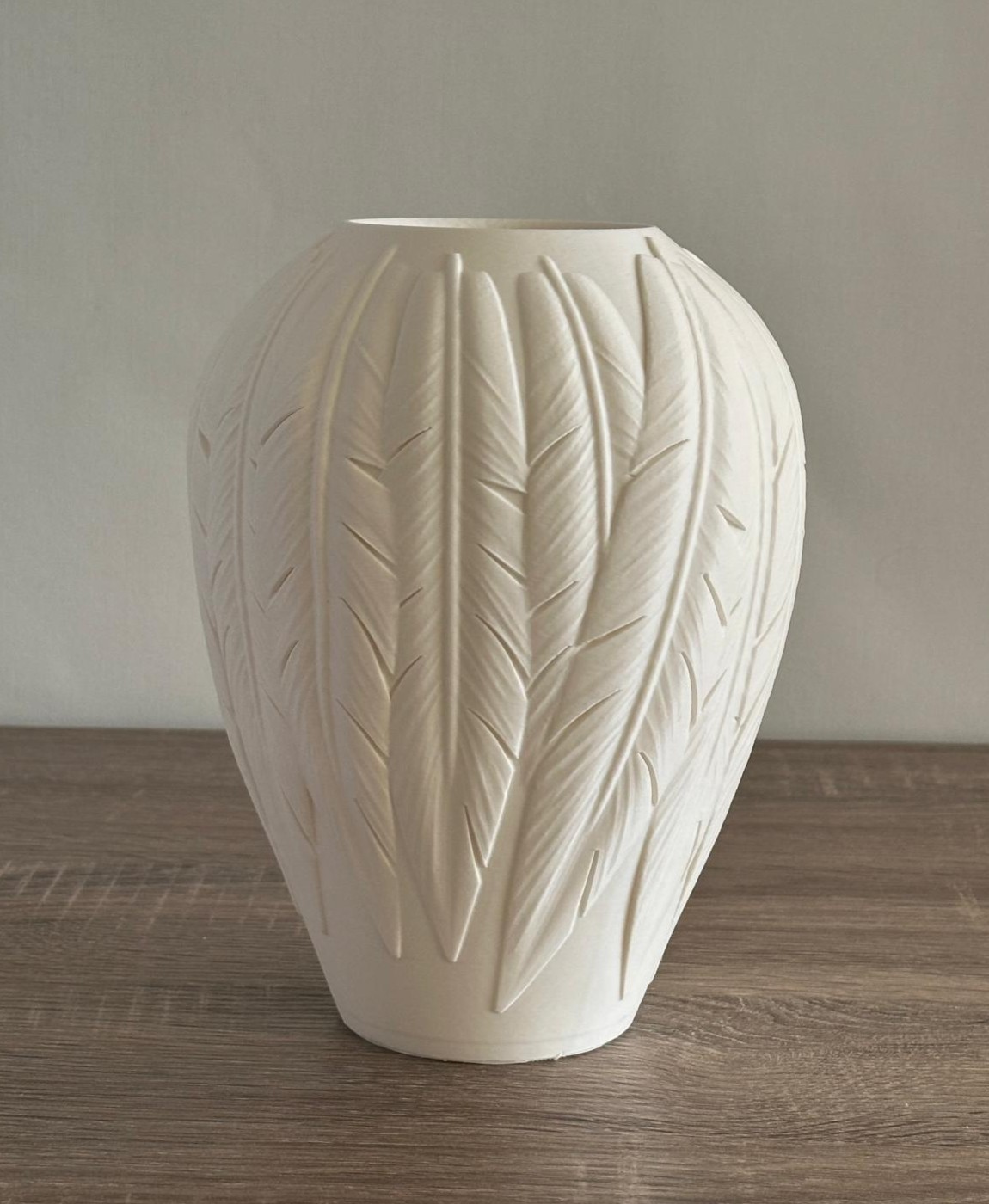 Vaso cerâmico branco com relevo em forma de penas