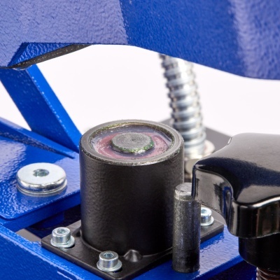 Peça metálica azul com botão preto e cilindro preto com superfície rosa