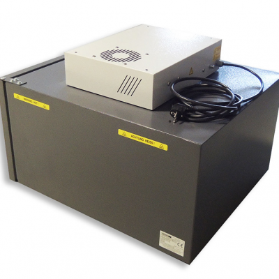 Equipamento eletrônico cinza escuro com unidade superior branca e cabos pretos enrolados.