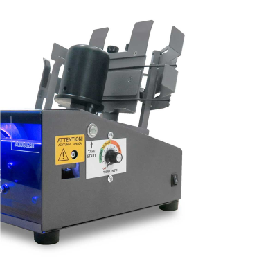 Máquina dispensadora de fita adesiva cinzenta com botões e etiquetas de aviso