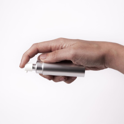 Frasco pulverizador metálico prateado na mão