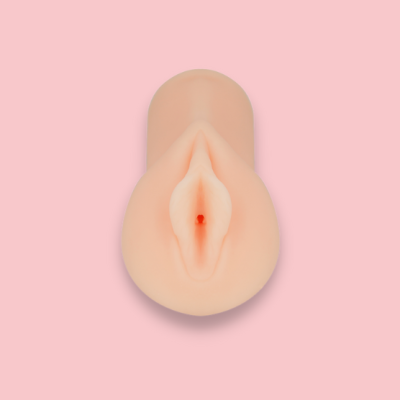 Objeto em forma de vagina realista de cor pele sobre fundo rosa