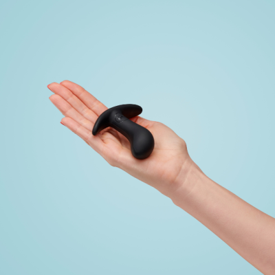 Dispositivo erótico preto de silicone em fundo azul