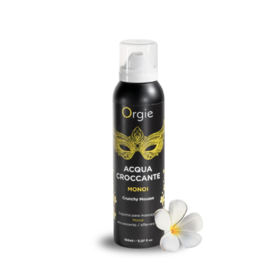 Frasco preto de mousse para massagem com tampa transparente e flor branca ao lado