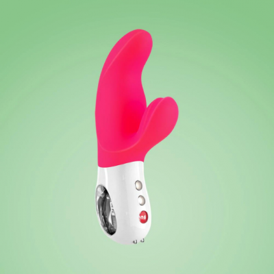 Vibrador rosa com base branca sobre fundo verde