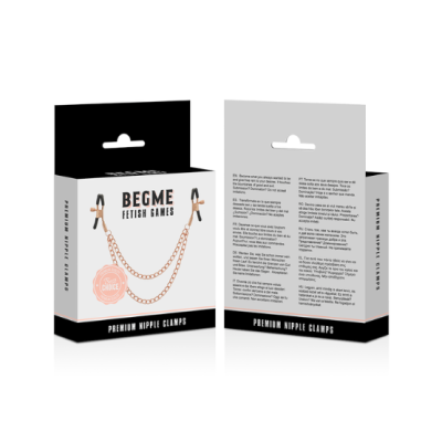 Embalagem preta e branca com clamps de mamilos e correntes douradas da marca BEGME FETISH GAMES