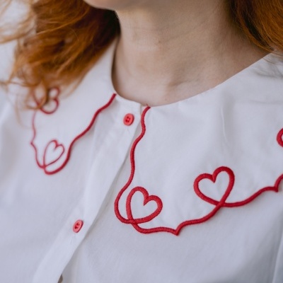 Blusa branca com bordado vermelho de corações e botões vermelhos