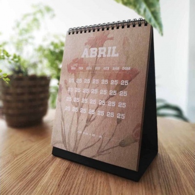 Calendário de mesa de papel castanho com espiral preta e mês de ABRIL impresso