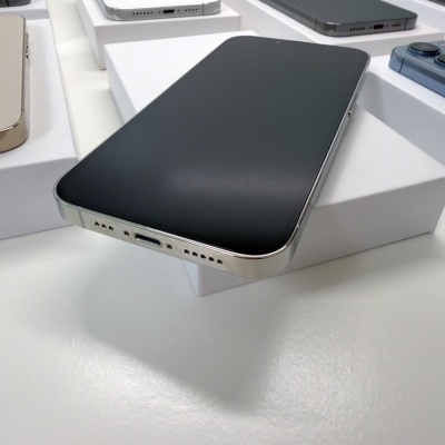 Vários smartphones Apple iPhone em diferentes cores sobre caixas brancas.