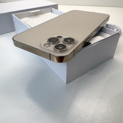 Smartphone bege com três câmeras em caixa branca