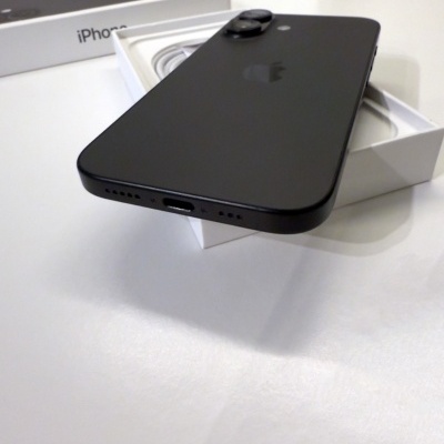 Smartphone preto tipo iPhone sobre caixa branca com texto