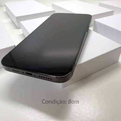 Smartphone preto com ecrã desligado sobre caixas brancas e texto Condição: Bom