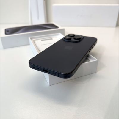 Smartphone preto com três câmaras traseiras em cima de caixa branca aberta