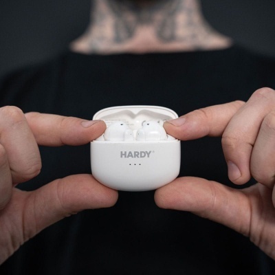 Estojo branco aberto com auriculares sem fios brancos da marca HAROY segurado por duas mãos.