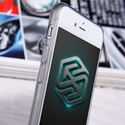 Smartphone branco com logotipo verde no ecrã e livro ao fundo