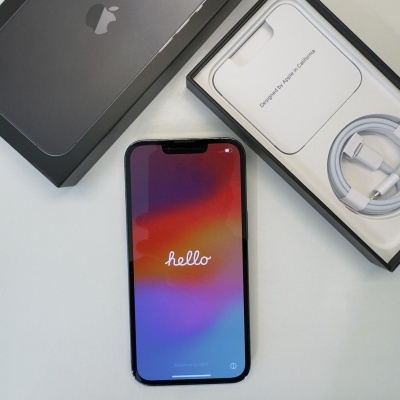 Smartphone Apple iPhone com ecrã ligado e embalagem