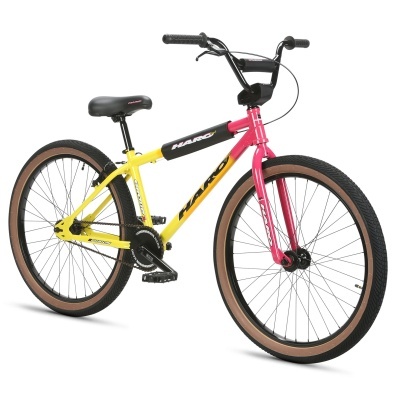 Bicicleta BMX HARO amarela e rosa com pneus castanhos e detalhes pretos