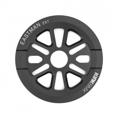 Peça redonda preta com aberturas e texto branco 'EASTMAN 25T' 'KINK BMX'
