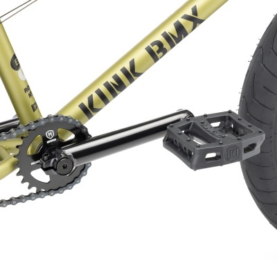 Parte inferior de bicicleta BMX dourada com texto KINK BMX e pedal preto