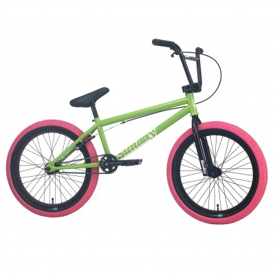 Bicicleta BMX verde com pneus cor-de-rosa sobre fundo branco