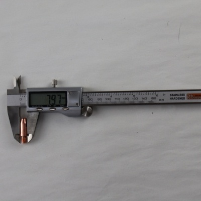 Paquímetro digital de metal medindo uma ponta de cobre