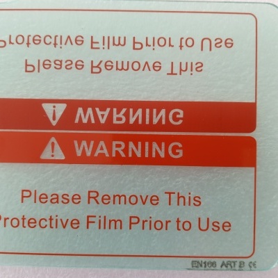 Etiqueta adesiva com aviso para remover película protetora antes do uso