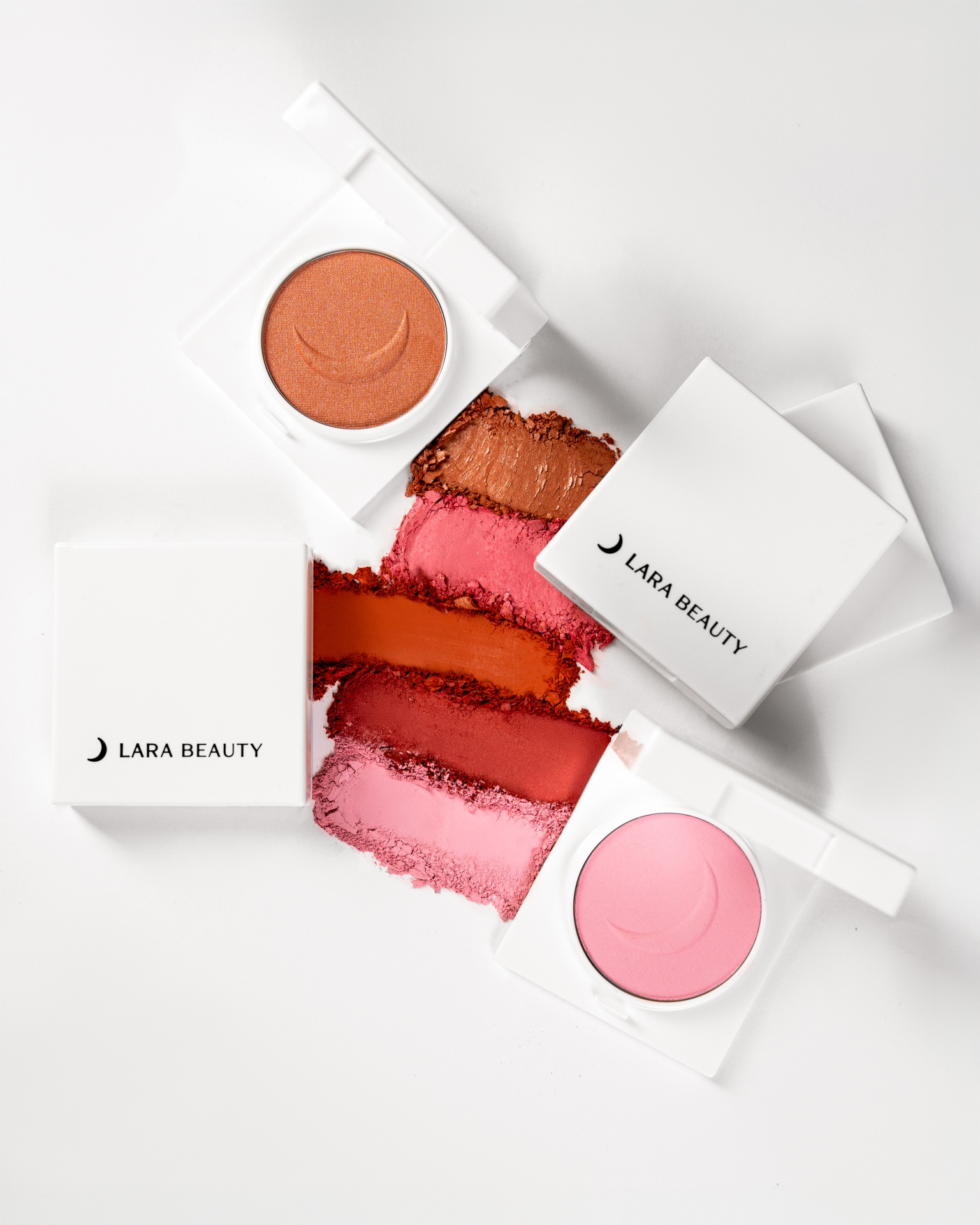 Blush Compacto Lara Beauty Paletas de maquilhagem de cores laranja, rosa e vermelho em caixas brancas LARA BEAUTY