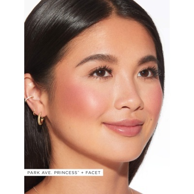 Mulher com brincos dourados e maquilhagem natural