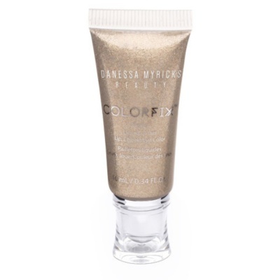 Tubo pequeno dourado cintilante de produto cosmético Danessa Myricks Colorfix com tampa branca