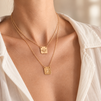 Colar duplo dourado com pingentes quadrados com motivos solares em pescoço feminino
