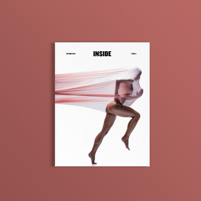 Capa de revista com imagem artística de mulher correndo envolta em tecido rosa e texto INSIDE.