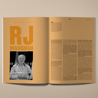 Revista aberta com entrevista de RJ Maughan, fundo castanho, texto grande e foto preto e branco
