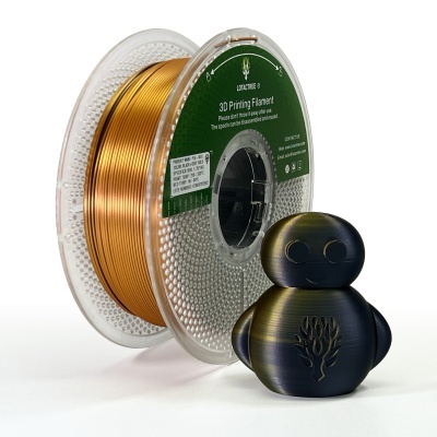 Carretel de filamento dourado metálico para impressão 3D junto com uma figura 3D preta com dourado e símbolo de árvore