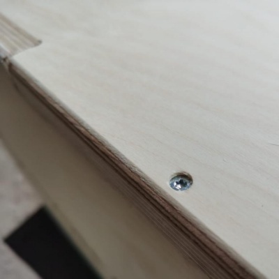 Superfície de madeira clara com parafuso prateado