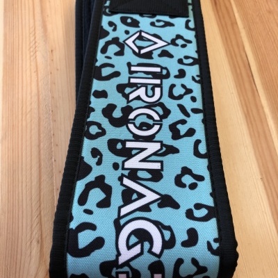 Cinta azul com padrão de manchas pretas e texto AIRONAGE sobre madeira clara.