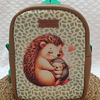Mochila infantil com estampa de ouriços e padrão de folhas verdes