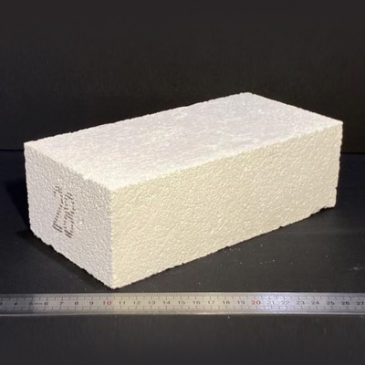 Bloco branco retangular com textura rugosa e números 726, sobre superfície preta com régua